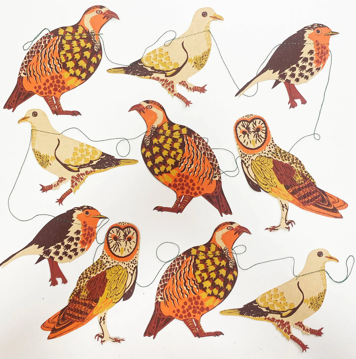 Image shows 10 species of birds in paper on a string, in colourations of orange, gold, brown and beige. Birds range from a Robin,Partridge and Owl.