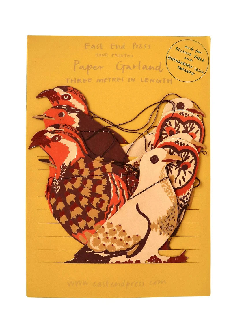 Picture shows paper birds packed in a bright mustard packaging with gold font including the words 'paper garland', 'east end press', 'three metre in length'.