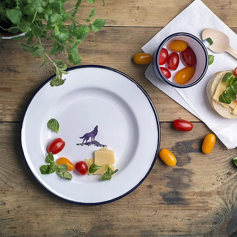 Emalco Enamelware 9.5 Wolf Plate: a white enamelware plate with a black rim and a striking purple silhouette of a howling wolf in the center, perfect for adventurers embarking on a mountain expedition.