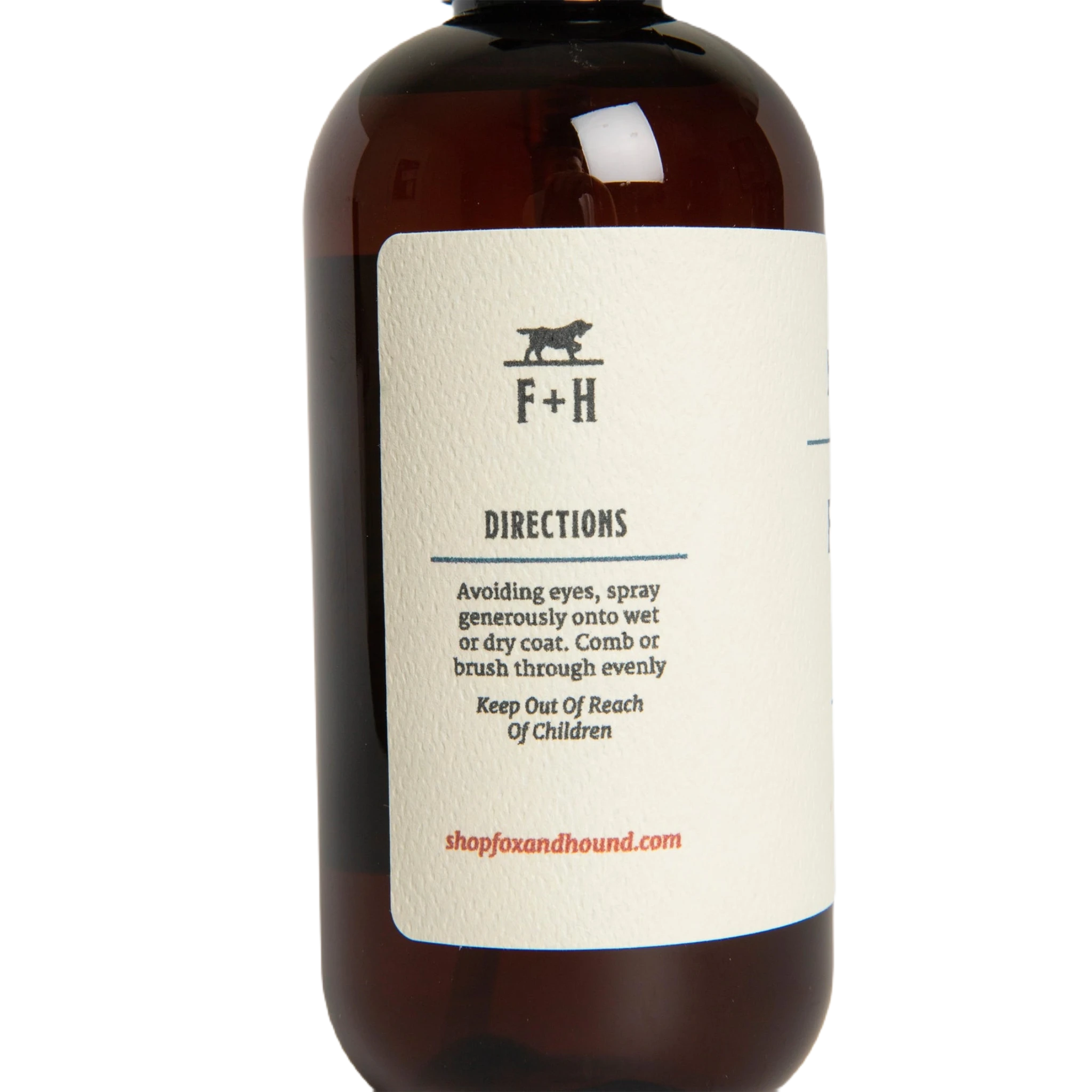 Against a plain white background, a brown bottle of Fox + Hound Dog Fragrance Spray, labeled "Redwood Amber," offers a long-lasting scent and serves as an effective pet odor solution.