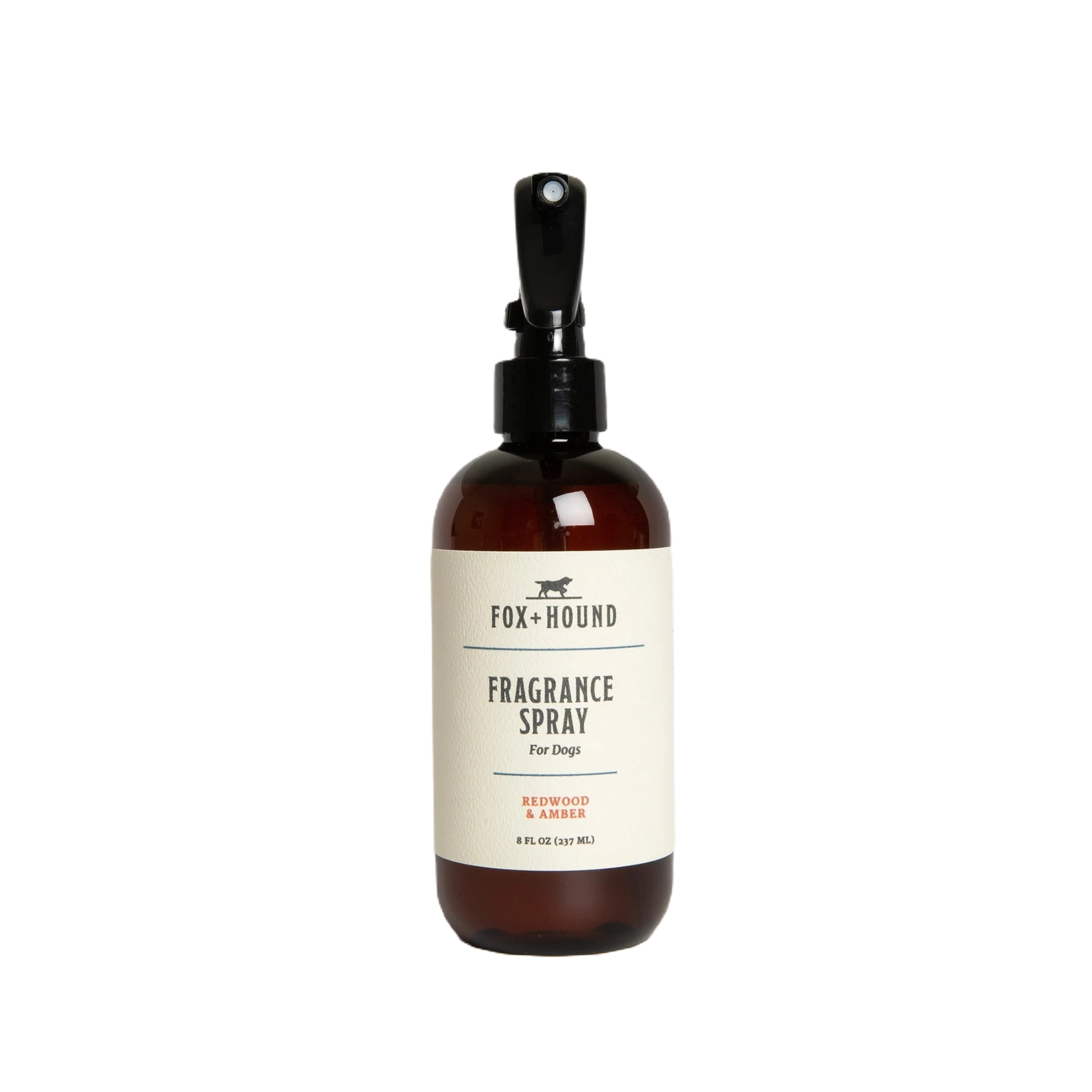 Against a plain white background, a brown bottle of Fox + Hound Dog Fragrance Spray, labeled "Redwood Amber," offers a long-lasting scent and serves as an effective pet odor solution.