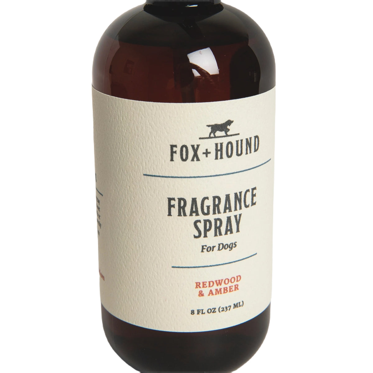 Against a plain white background, a brown bottle of Fox + Hound Dog Fragrance Spray, labeled "Redwood Amber," offers a long-lasting scent and serves as an effective pet odor solution.