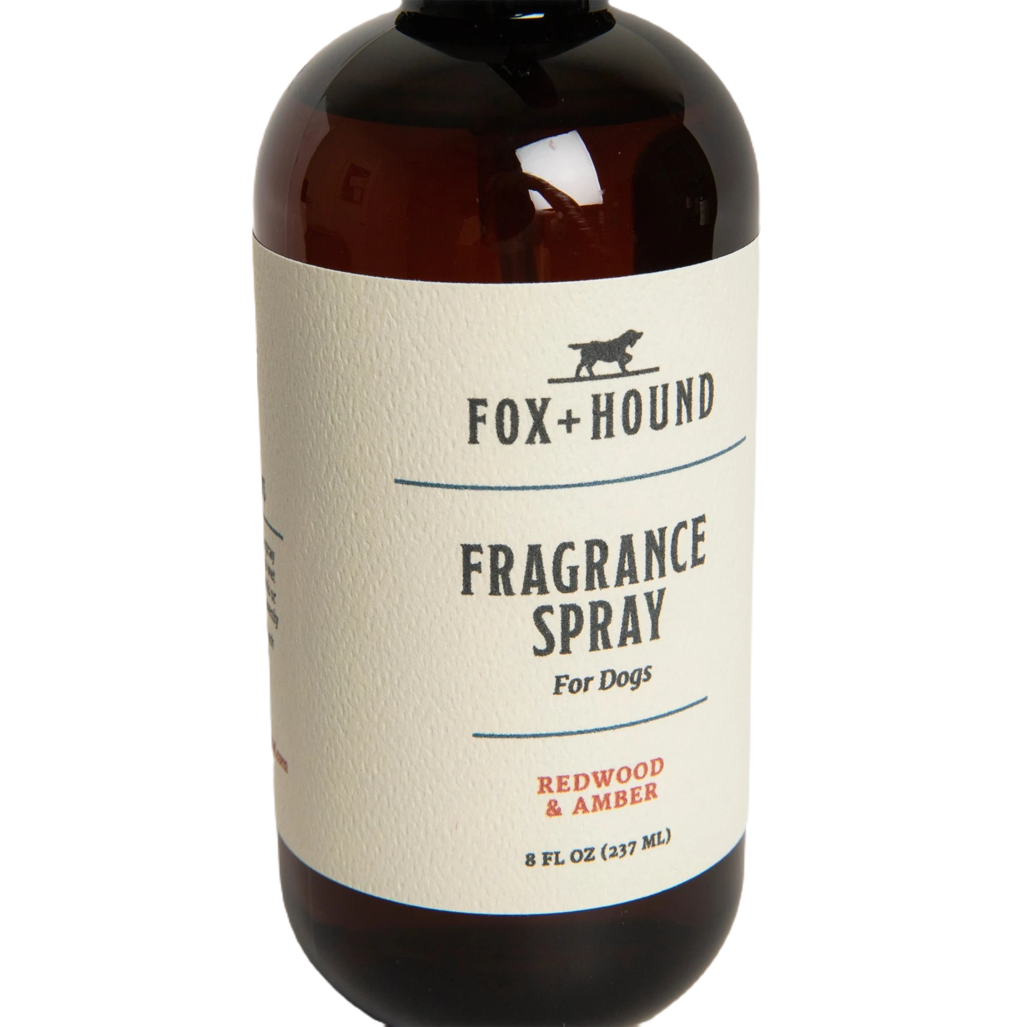 Against a plain white background, a brown bottle of Fox + Hound Dog Fragrance Spray, labeled "Redwood Amber," offers a long-lasting scent and serves as an effective pet odor solution.