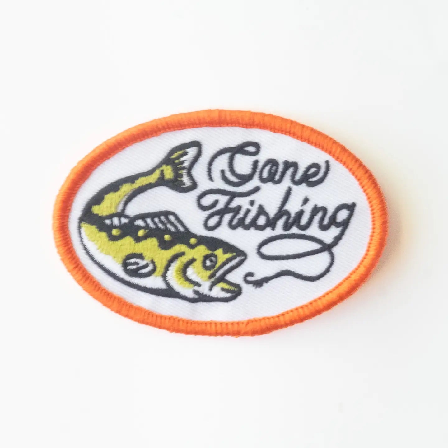 Union Made “Gone Fishing” patch, oval shape, orange border, yellow fish, black script—ideal iron-on for outdoor or fishing fans.