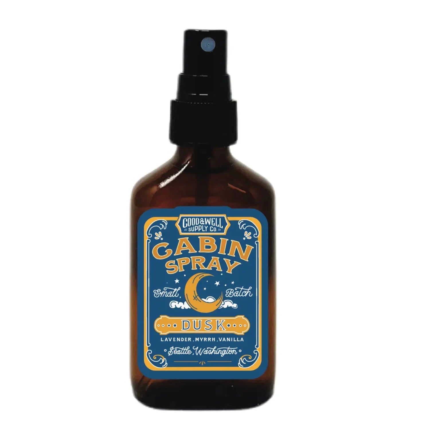 The "Good & Well Supply Co Cabin Room Spray - Dusk" is a brown spray bottle with a blue and yellow label, featuring scents of lavender, myrrh, and vanilla. This apothecary-style spray is perfect for creating a cozy cabin atmosphere.