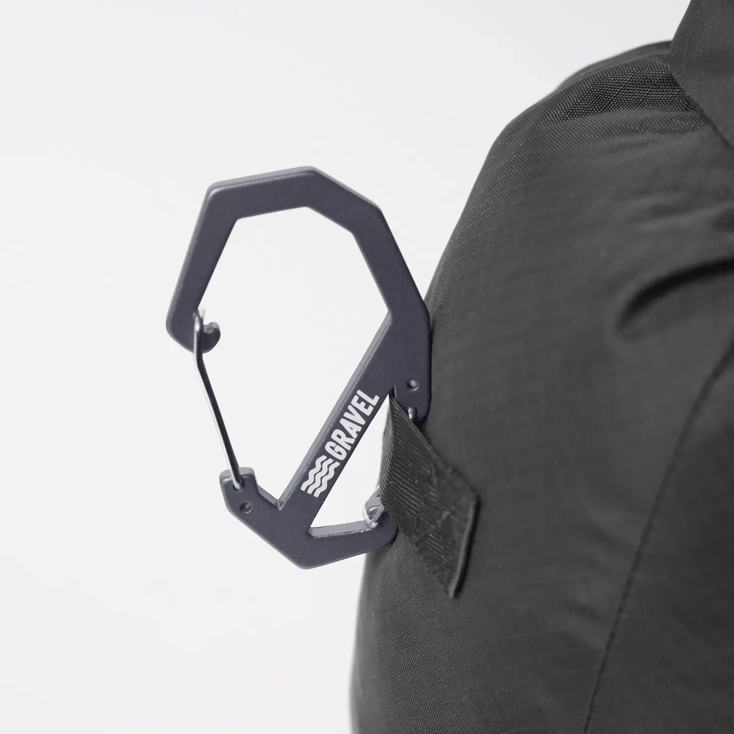 Black backpack with a carabiner attached on a white background