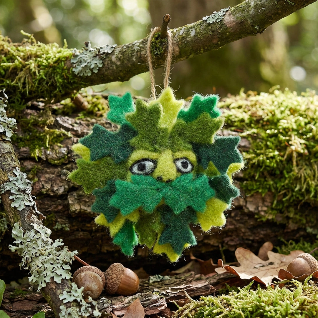 Forager Provisions LTD handmade felt Green Man hanging decoration with layered green leaves in a woodland setting.