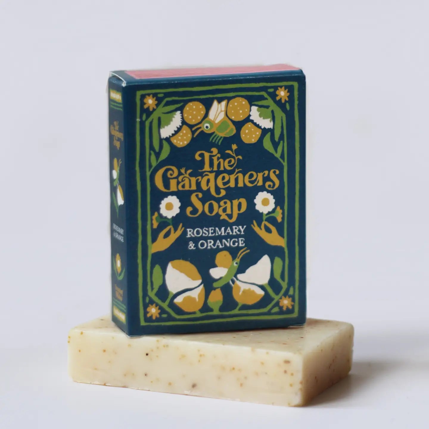 A Growing Wilder Gardeners Soap Rosemary & Orange box displayed upright atop soap bar, simple background. Natural organic skincare.