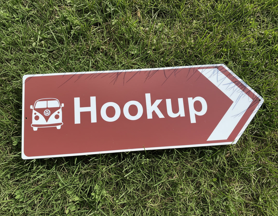 Directional sign pointing right with a Volkswagen van icon and the word 'Hookup' on a grass background.