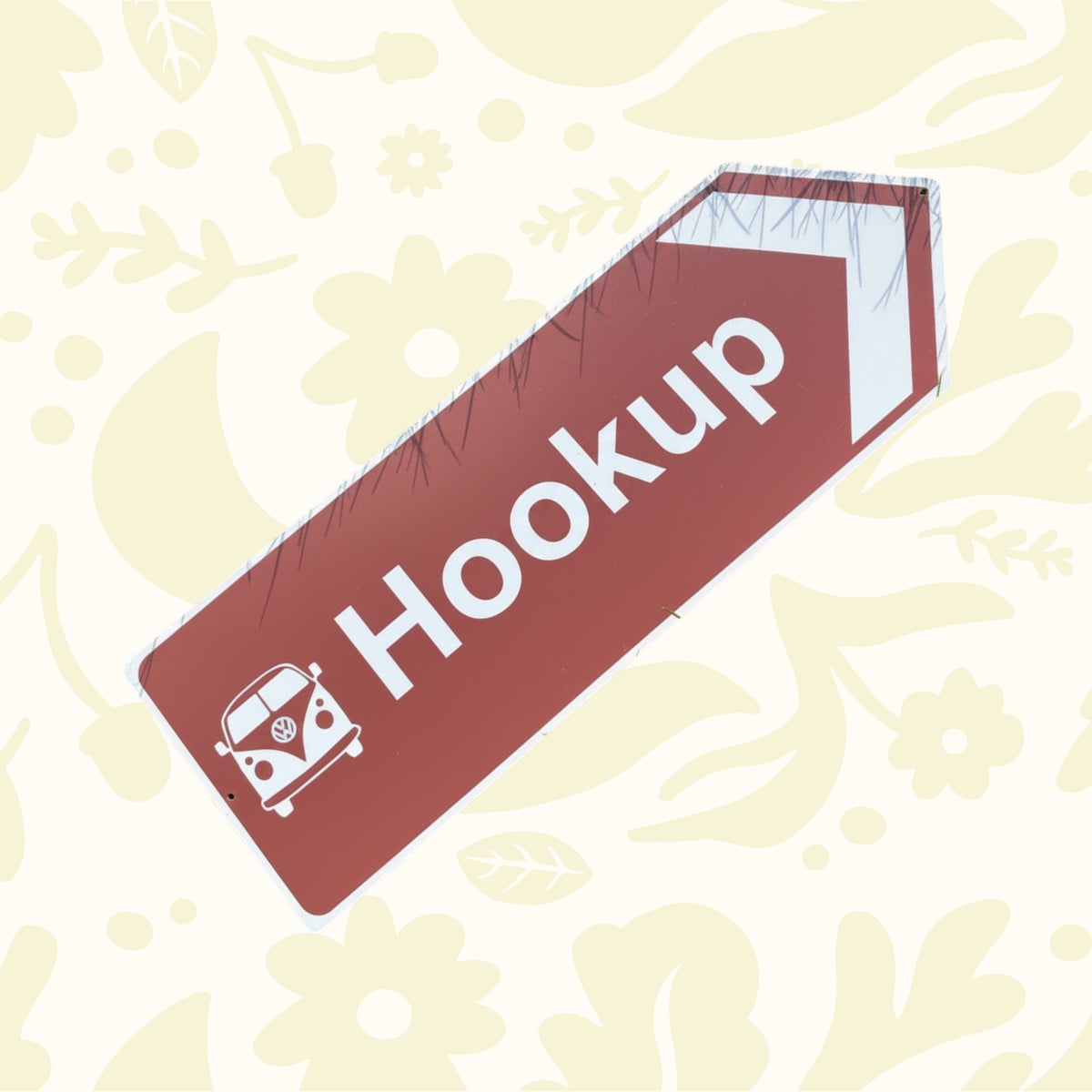 Directional sign pointing right with a Volkswagen van icon and the word 'Hookup' on a grass background.