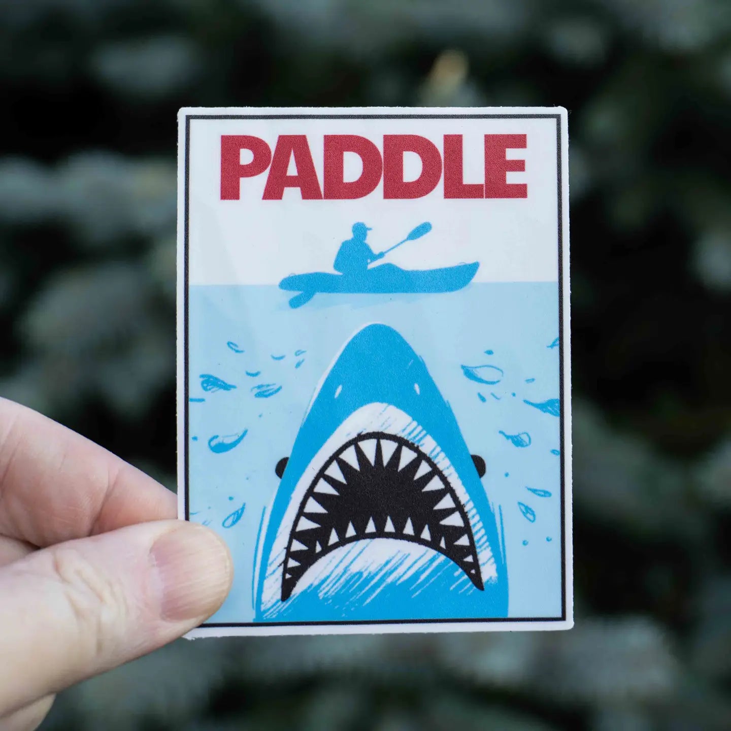 Hand holding Hey Bear Outdoors Jaws Kayak Paddle Sticker, ideal kayak accessory or unique paddling gift for kayakers.