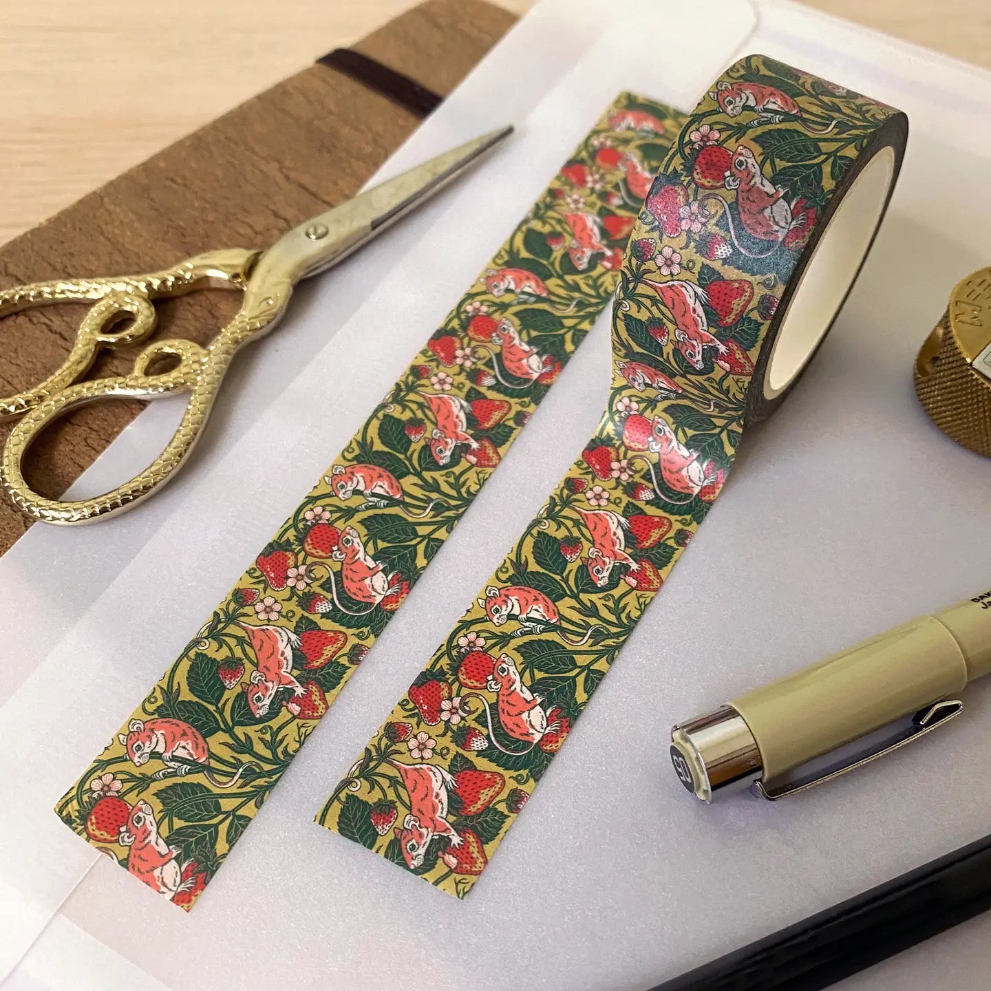 Kate O’Hara Strawberry Mouse Washi Tape, scissors, pen, and stationery supplies arranged on table for crafting or journaling.