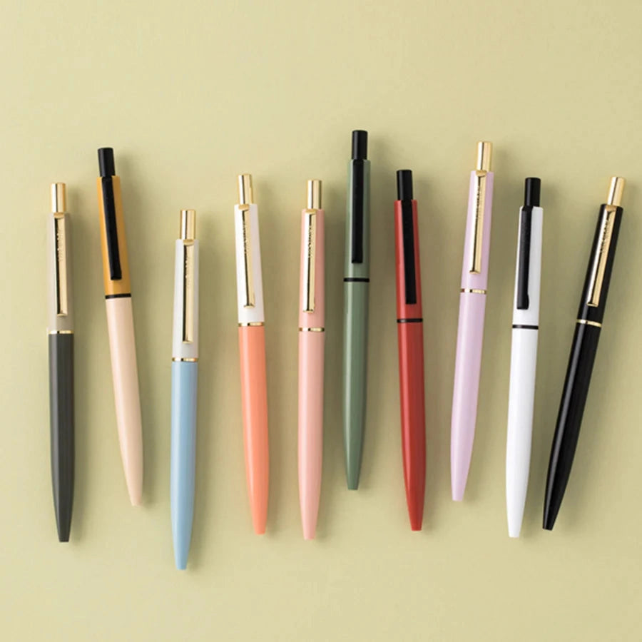 Ten Livework LIVE & PIECES Classic Ballpoint Pens, Orange/Red, neatly set on beige. Stylish pen set for office or school.