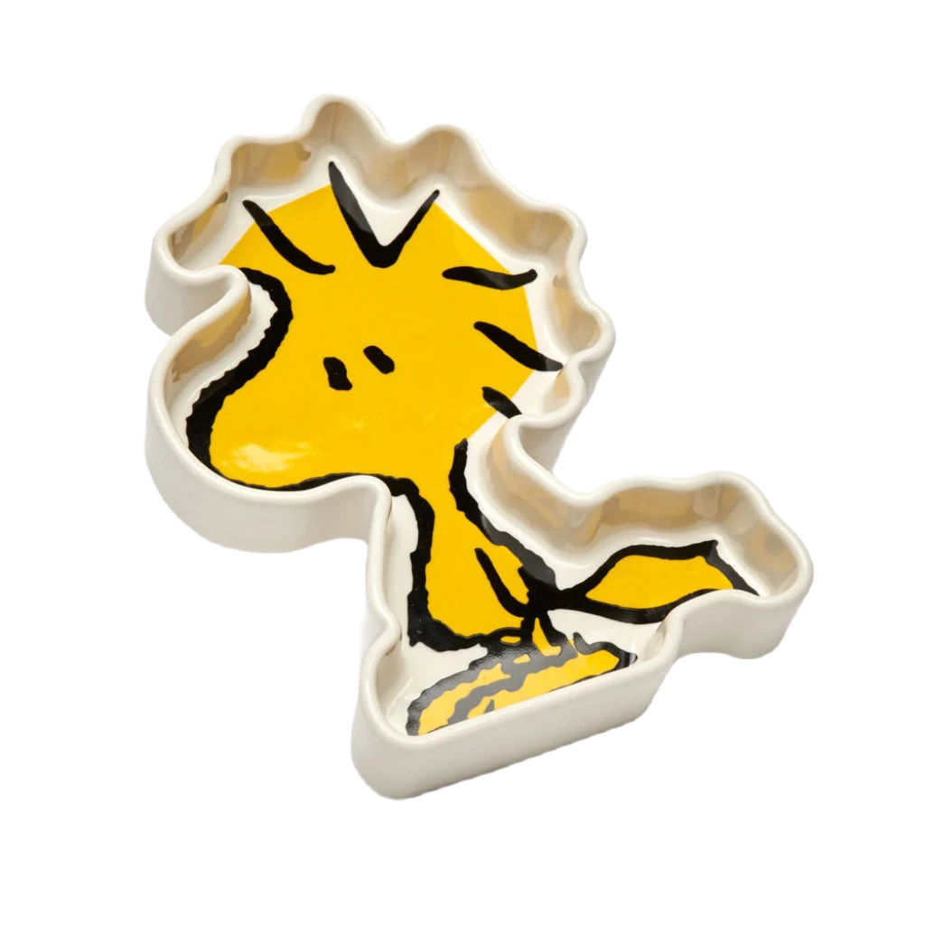 Magpie Gifts Woodstock Shaped Trinket Tray, a ceramic dish designed and painted to look like the yellow bird Woodstock from the Peanuts homewares collection, features black outlines and a white background.