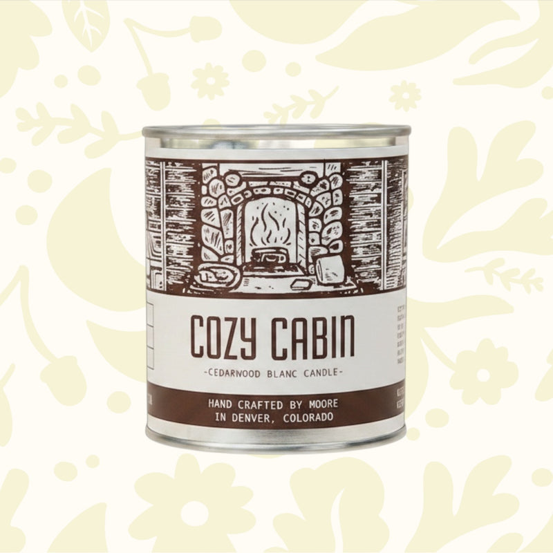 Forager Provisions LTD Moore Collection Cozy Cabin soy wax candle in a rustic metal tin with woodsy scent notes