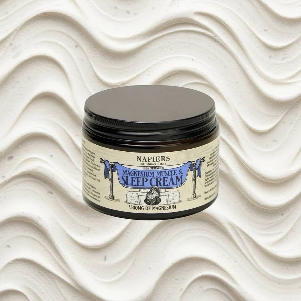 Napiers Magnesium Muscle & Sleep Cream 325g jar on a wavy off-white backdrop, natural pain relief and sleep aid.