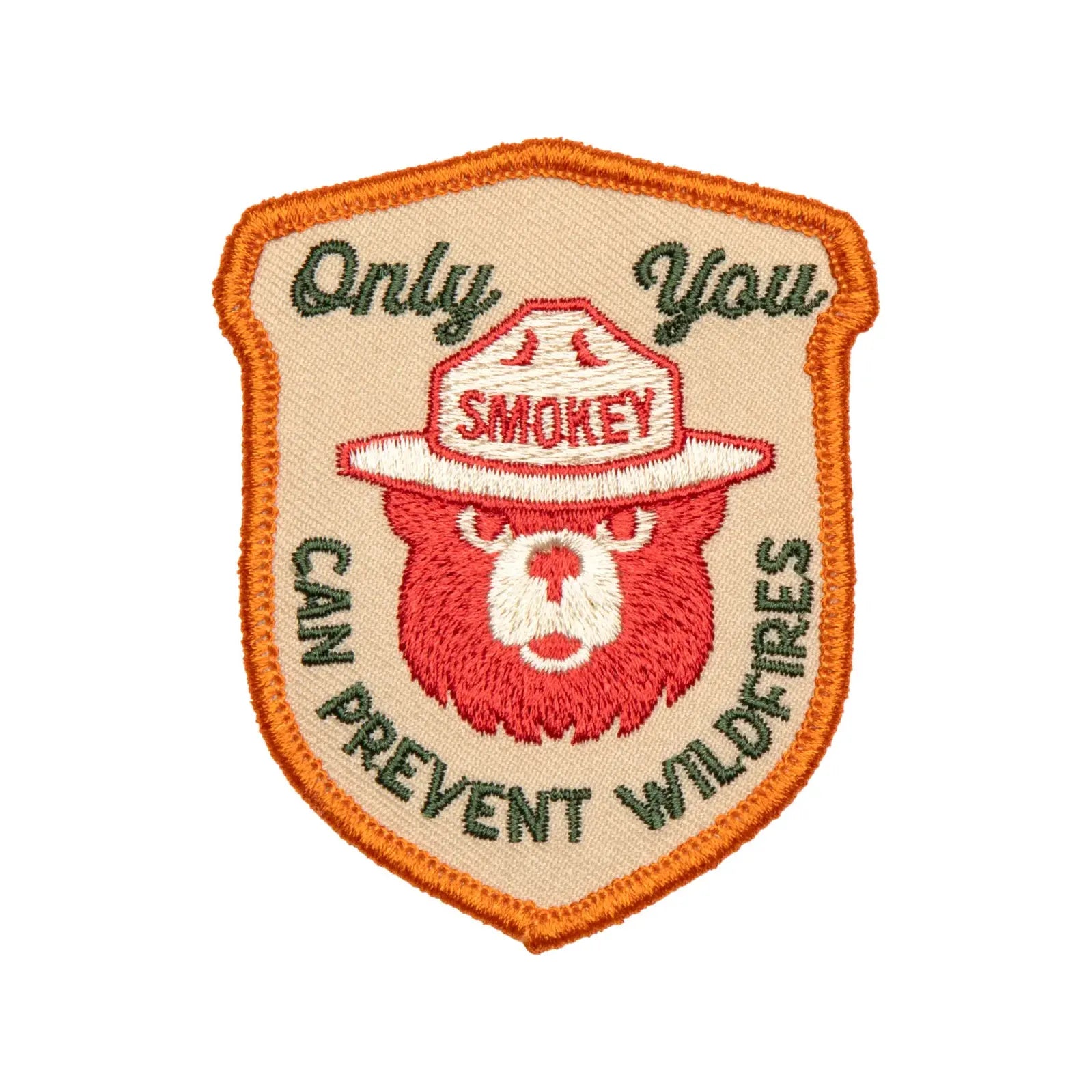 This licensed product, The Landmark Project Smokey Bear Patch - Only You Heritage, is an embroidered patch featuring Smokey Bear wearing a ranger hat and the text "Only You Can Prevent Wildfires." It is thoughtfully packaged by The Landmark Project.
