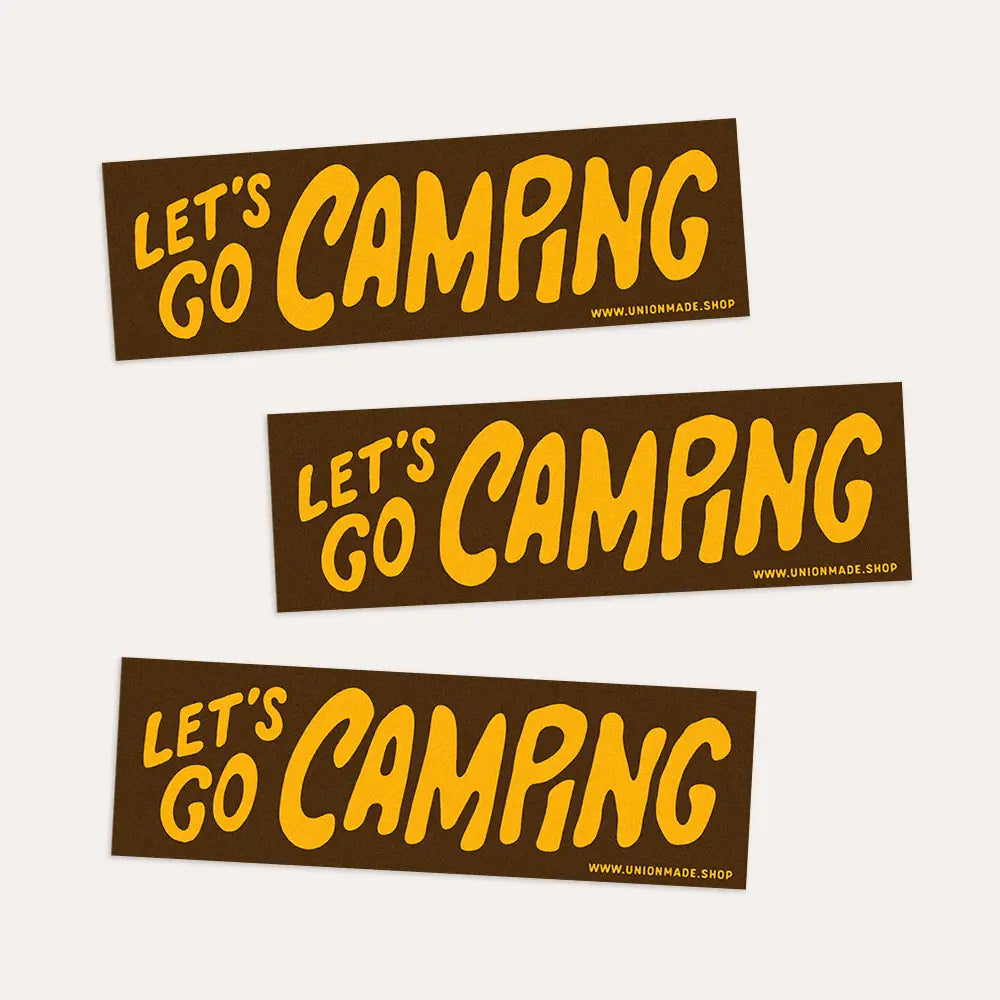 Brown Union Made "Let's Go Camping" bumper stickers with bold yellow text and a small website URL, perfect camping accessory.