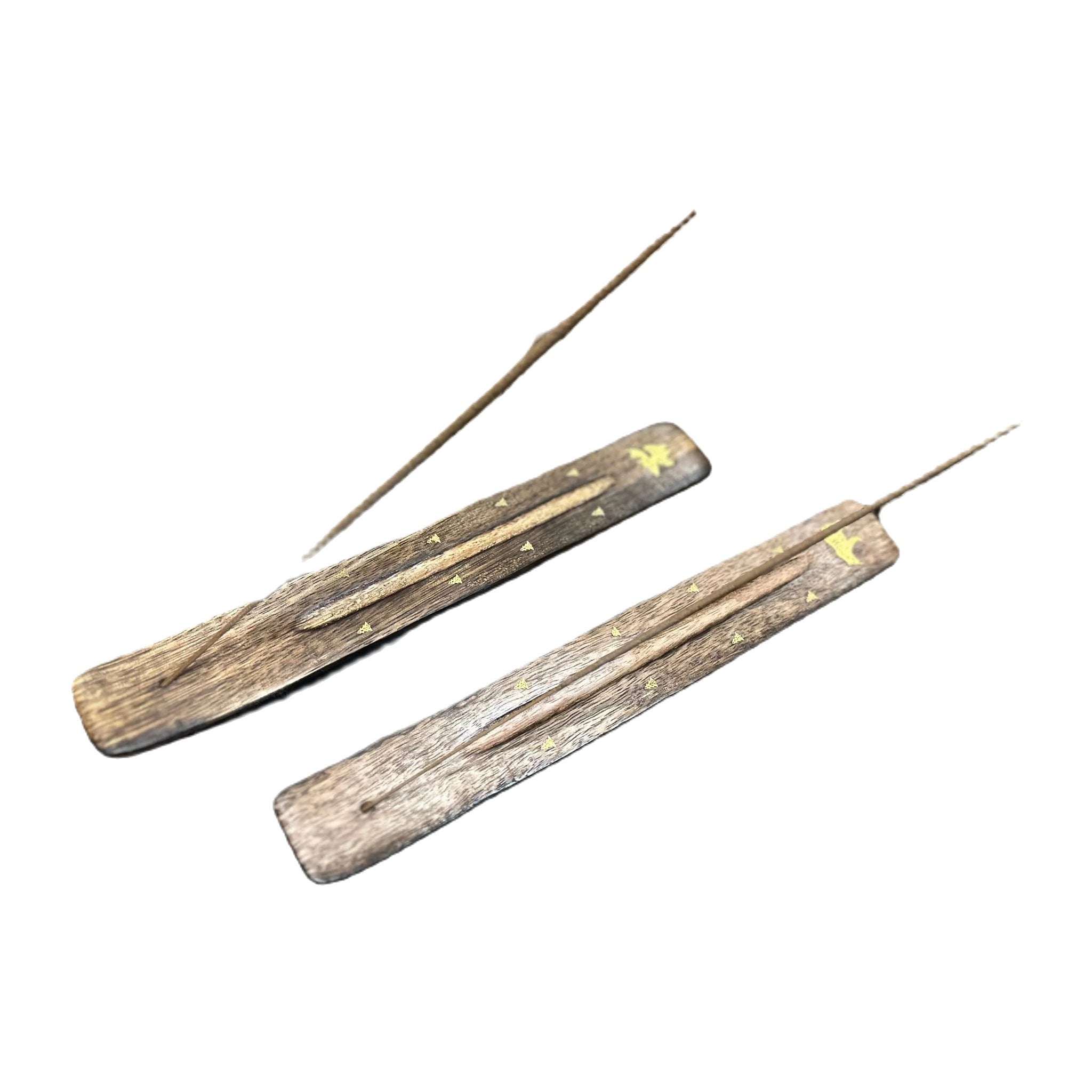 Two PAINES Wood Ash Catcher Incense Holders, each adorned with bear designs and currently holding burning incense sticks, rest elegantly on a rustic wooden surface.