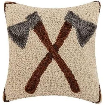 The Peking Handicraft Axe Hook Cushion is a wool accent pillow with a textured surface, showcasing a design of two crossed axes—one with a brown handle and the other with a gray handle—against a cream background, adding rustic charm to any space.