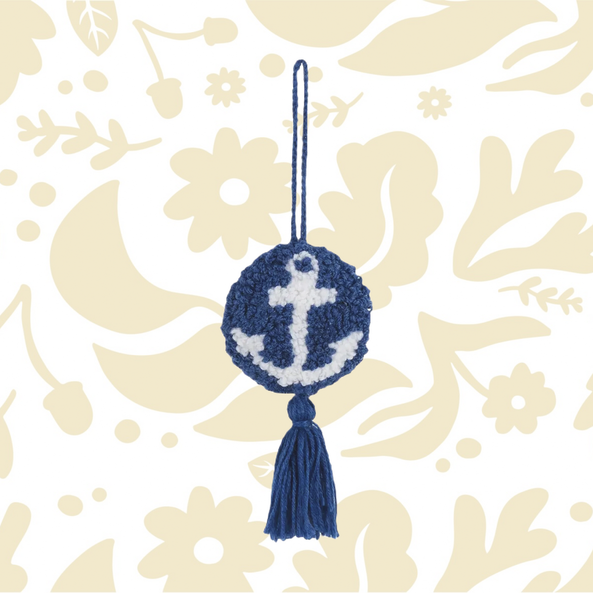 The Peking Handicraft Hanging Anchor Decoration features a blue crochet tassel with a white anchor design in the center, attached by a blue string loop and equipped with a poly hook for easy hanging.