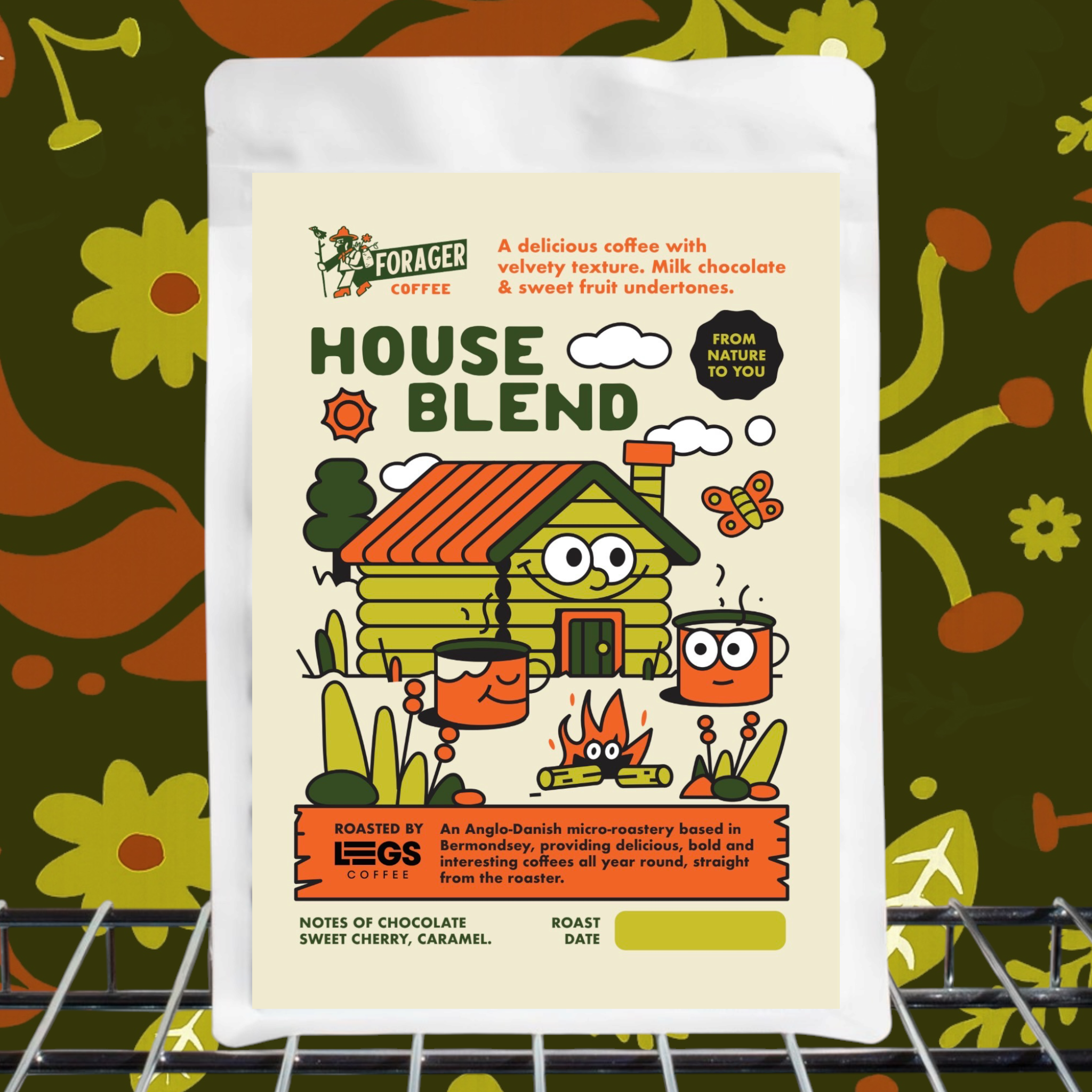 Forager Provisions 250g House Blend coffee beans on metal shelf, floral background, rustic cabin label, specialty coffee.
