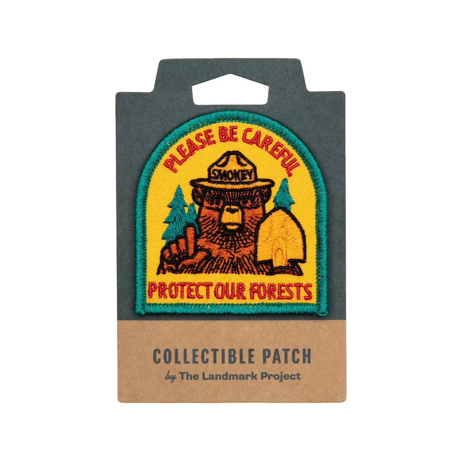 The Landmark Project Smokey Bear Patch - Protect Our Forests showcases a collectible patch with a bear in a ranger hat and the text "Please Be Careful Protect Our Forests," echoing Smokey Bear's iconic wildfire prevention message.