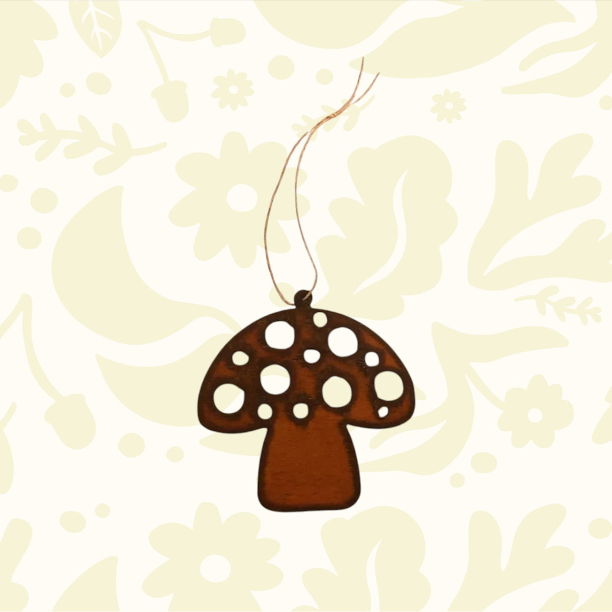 Universal Ironworks Redcap Mushroom Hanging Decoration suspended by string, displayed on white wooden background farmhouse decor.