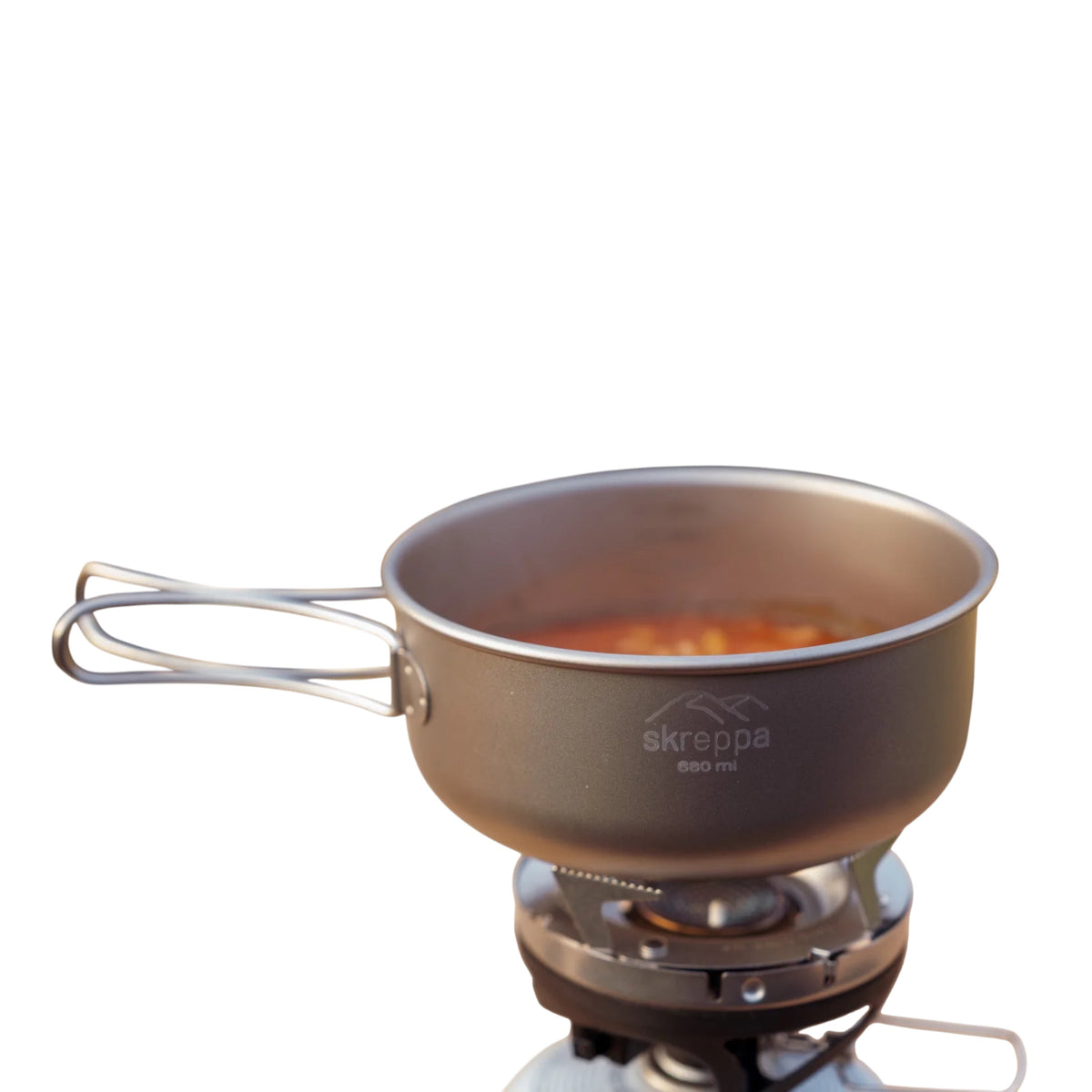 Skreppa 3 Piece Titanium Camping Cook Set pot on stove, food cooking inside—ultralight outdoor cookware for backpacking.