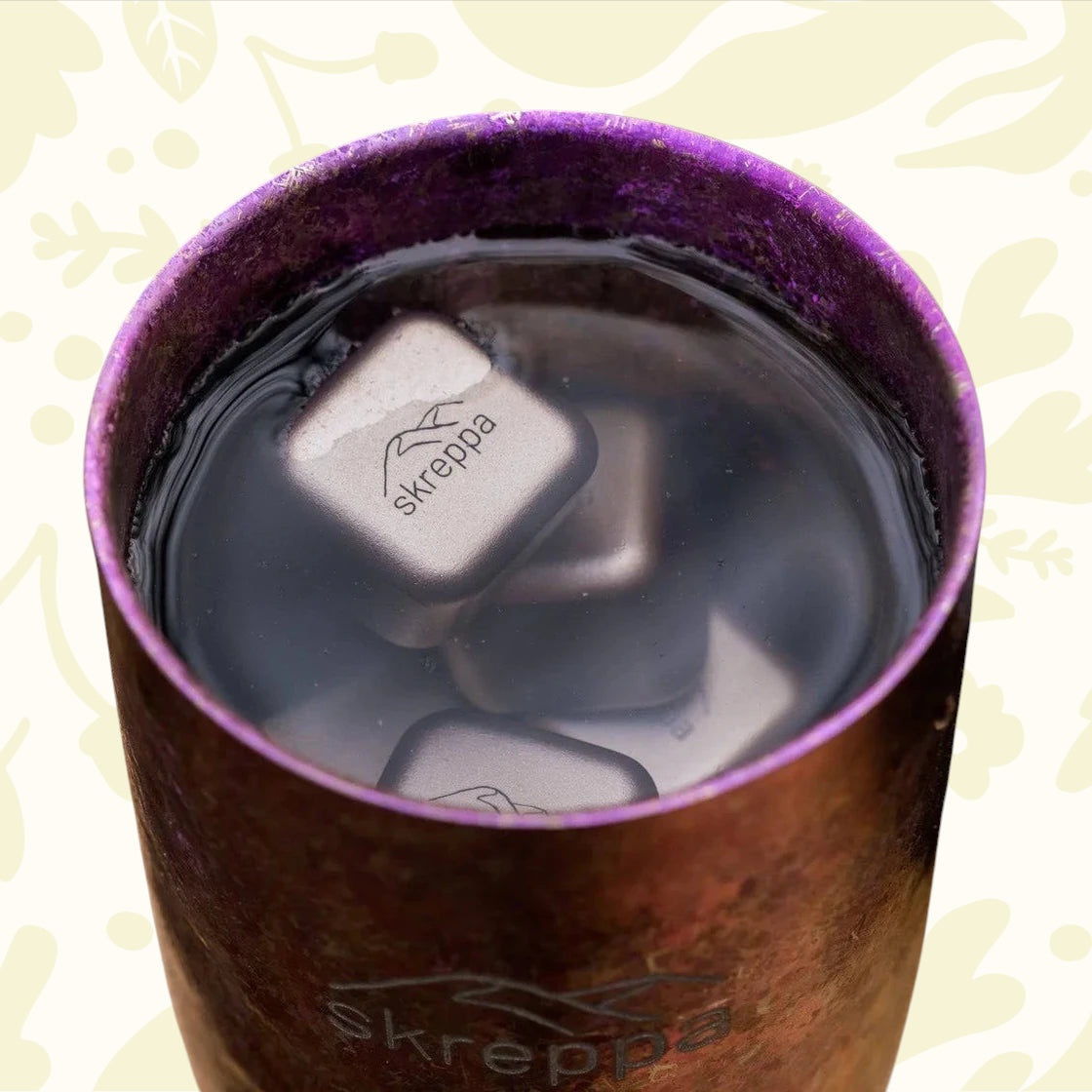 Skreppa branded metal tumbler chilled perfectly with Skreppa Titanium Ice Cube Set for ultimate drink cooling and freshness.