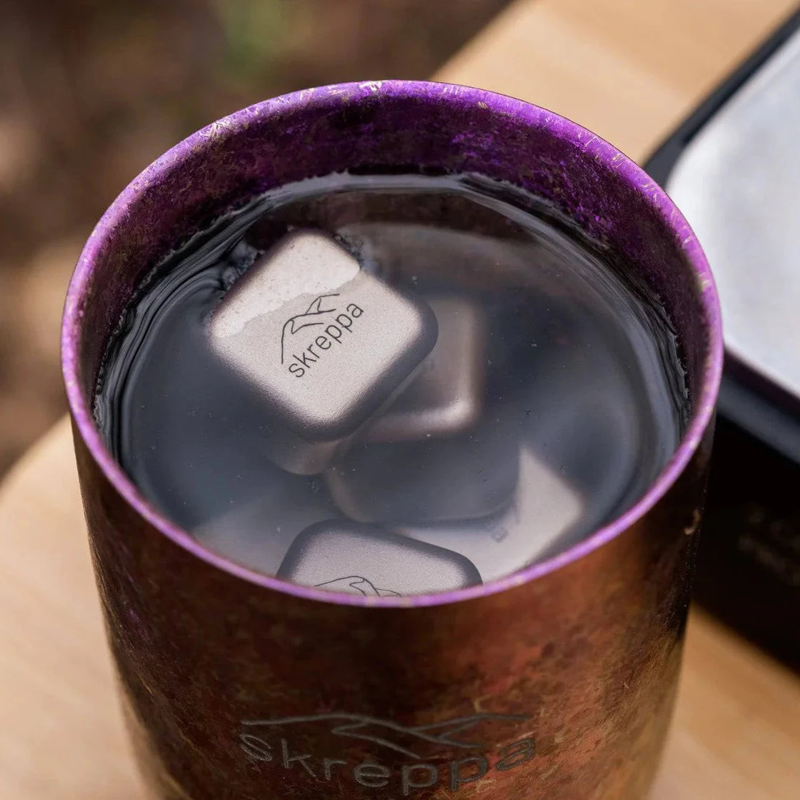 Skreppa branded metal tumbler chilled perfectly with Skreppa Titanium Ice Cube Set for ultimate drink cooling and freshness.