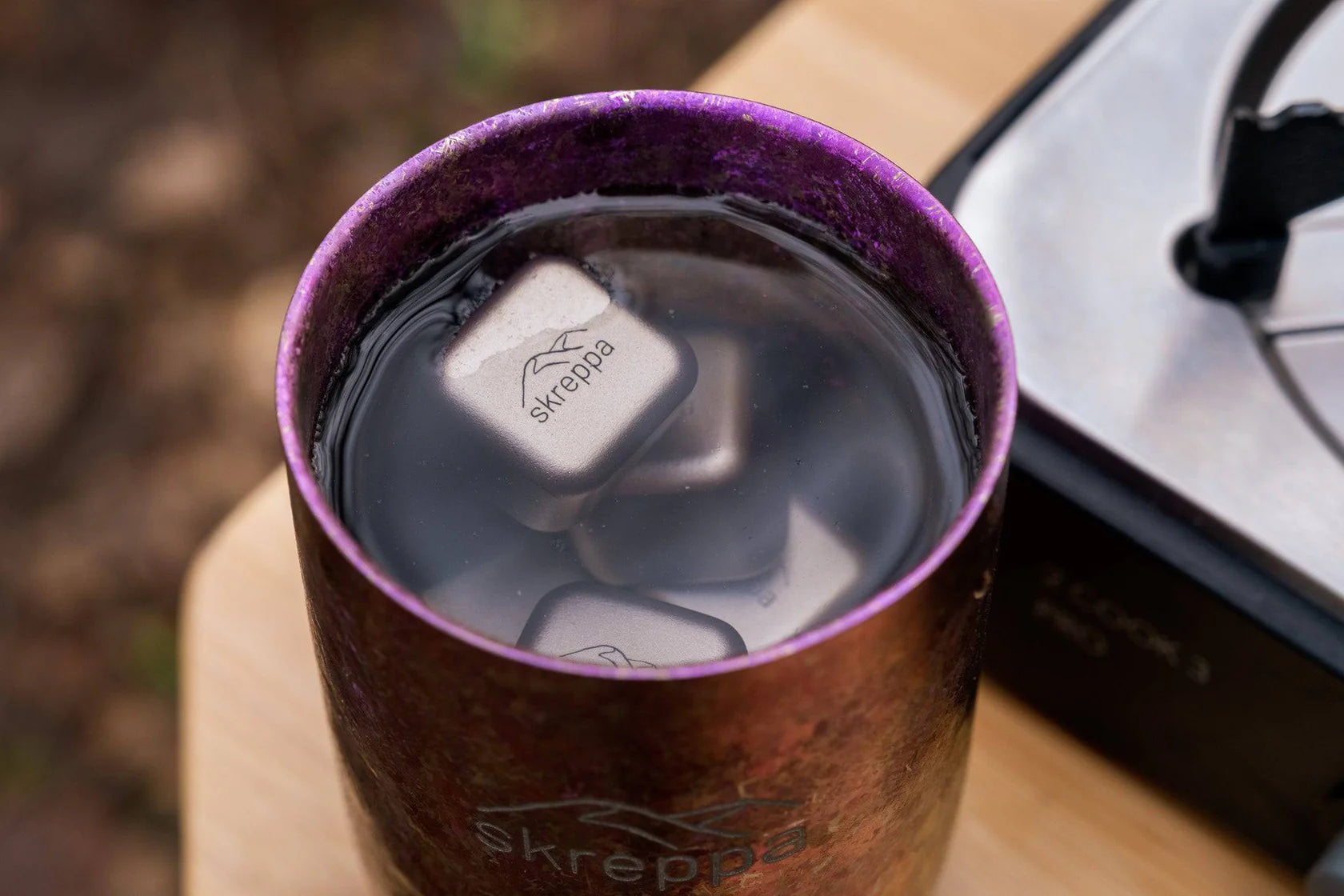 Skreppa branded metal tumbler chilled perfectly with Skreppa Titanium Ice Cube Set for ultimate drink cooling and freshness.