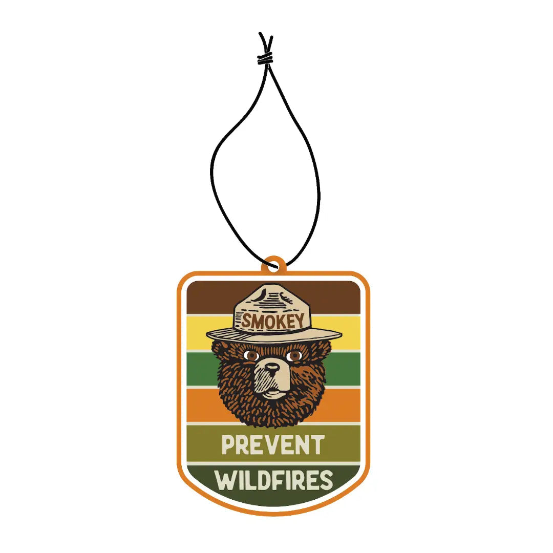 Forager Provisions LTD Smokey Bear hanging air freshener with retro striped background and pine and citrus scent.