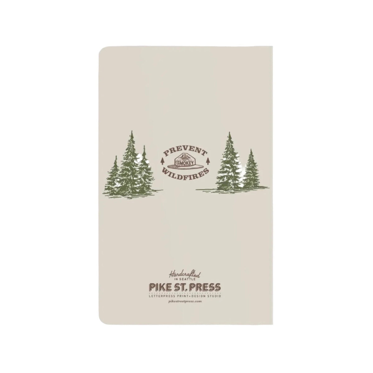 Image shows the back of a notebook with fir trees in green middle left and right with a smokey hat logo in the middle.