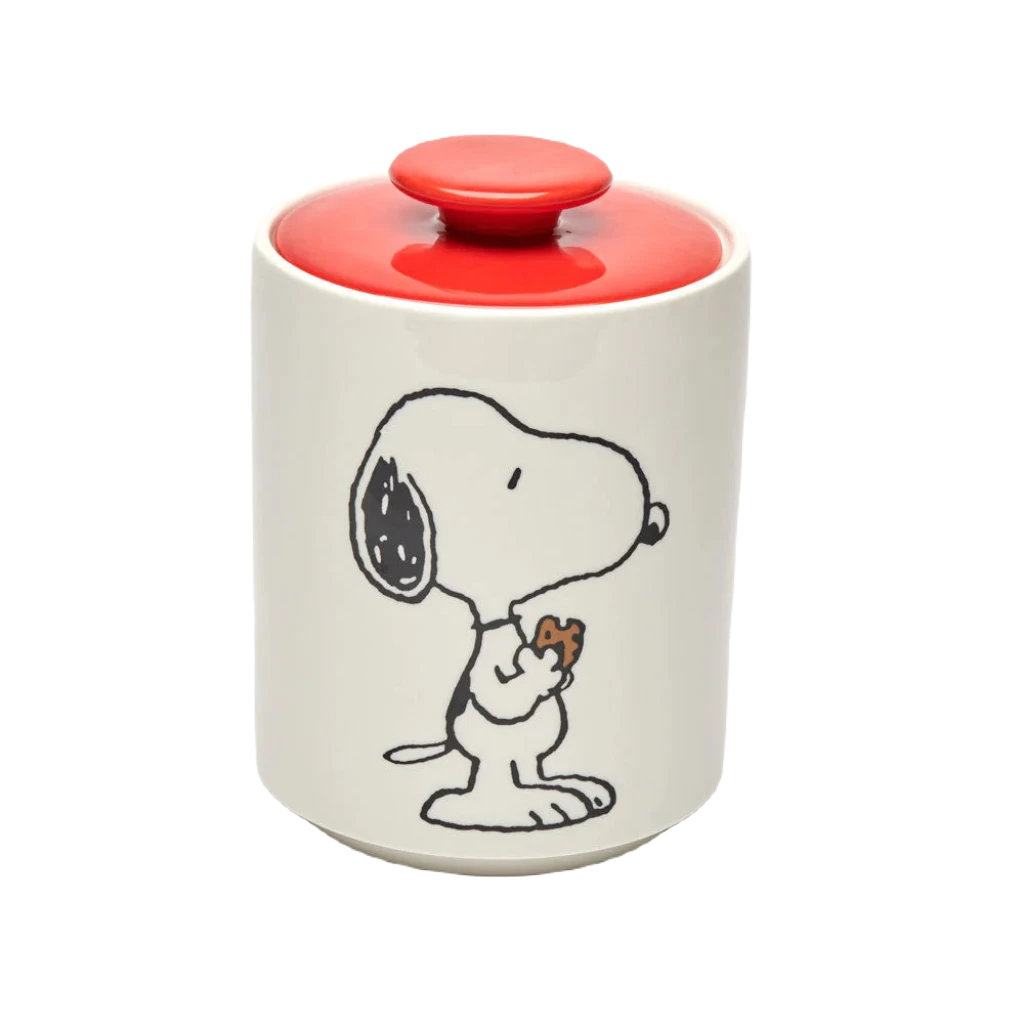 The Magpie Gifts Snoopy Cookie Jar is a delightful white ceramic piece featuring a red lid and adorned with a cartoon image of Snoopy from Peanuts holding a heart.