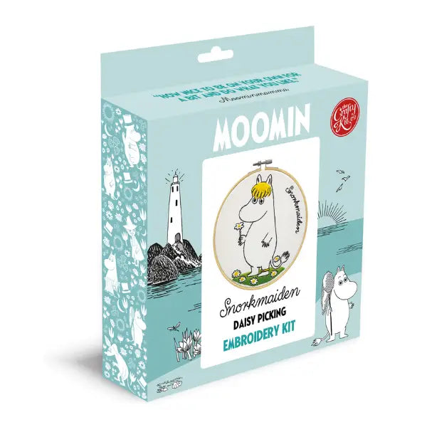 The Crafty Kit Company Snorkmaiden Daisy Cross Stitch kit features the charming Snorkmaiden character holding a flower, surrounded by daisies, with the word "Snorkmaiden" on the side. This delightful embroidery kit makes for a perfect beginner project.