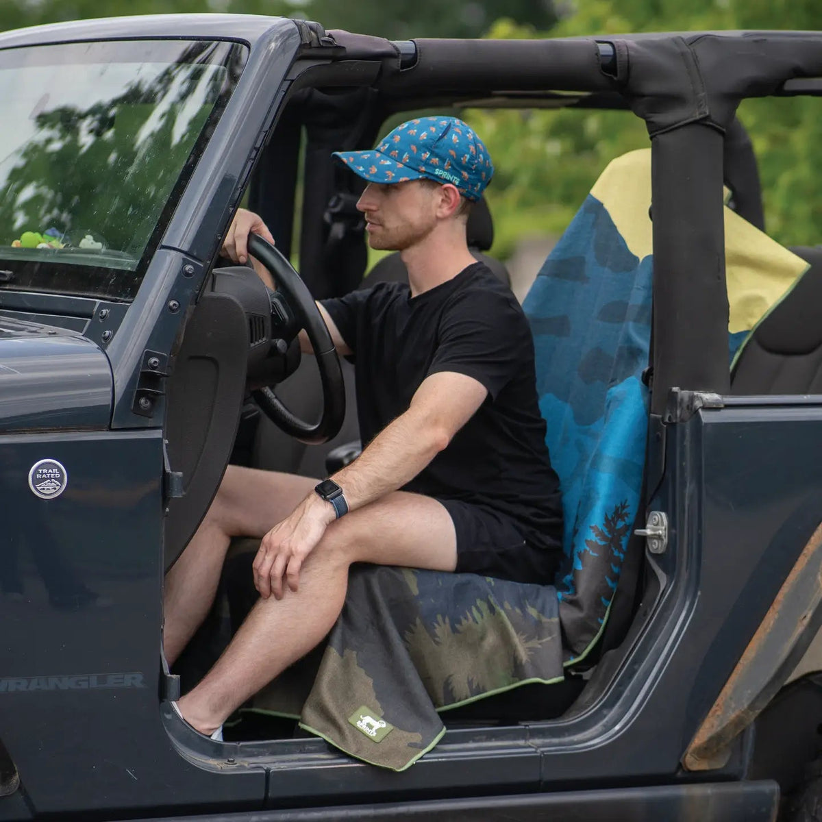 Forager Provisions LTD Sprints Grizzly Guide car seat cover towel featuring a mountain forest print in a Jeep