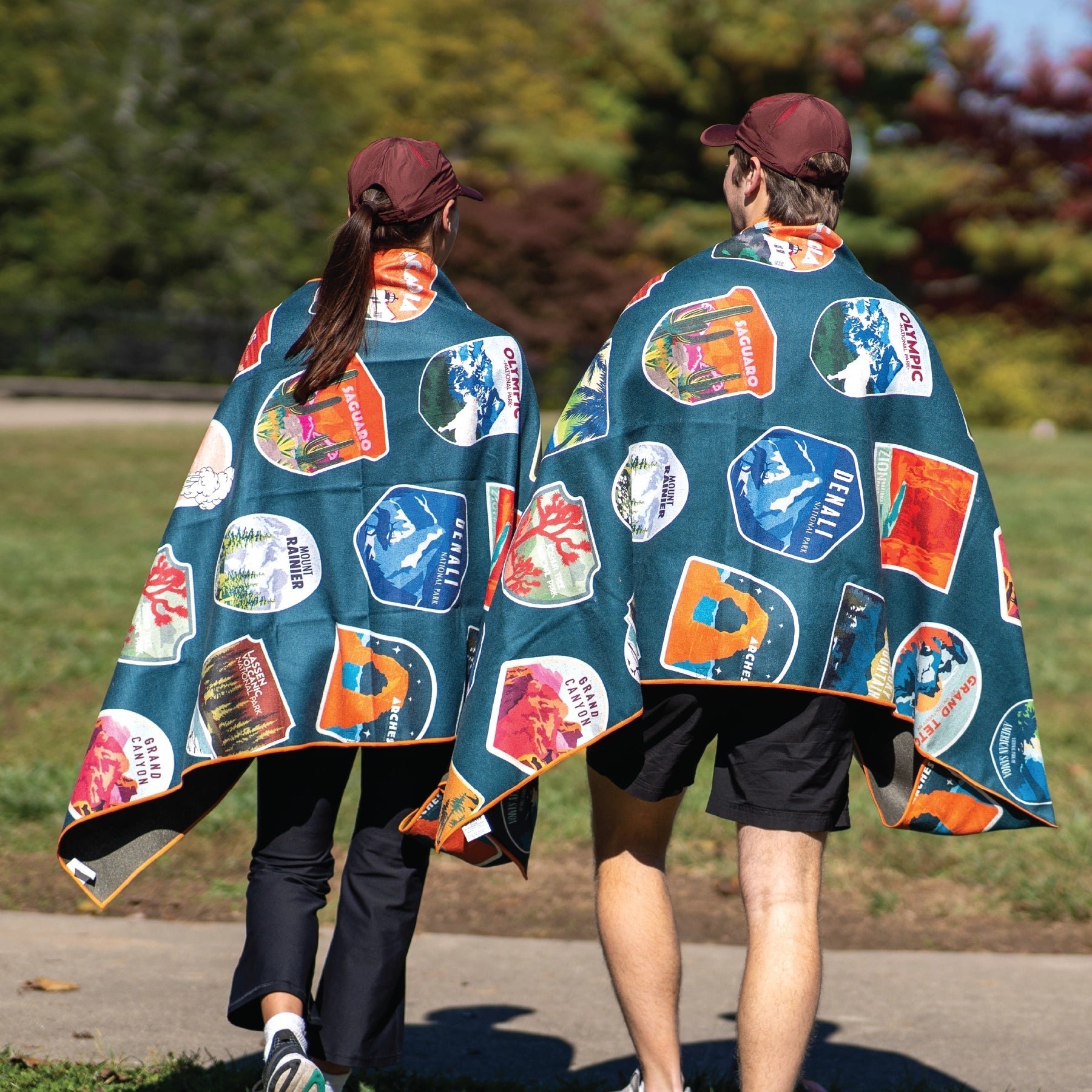 Forager Provisions LTD Sprints National Parks microfibre towel draped over two people walking outdoors