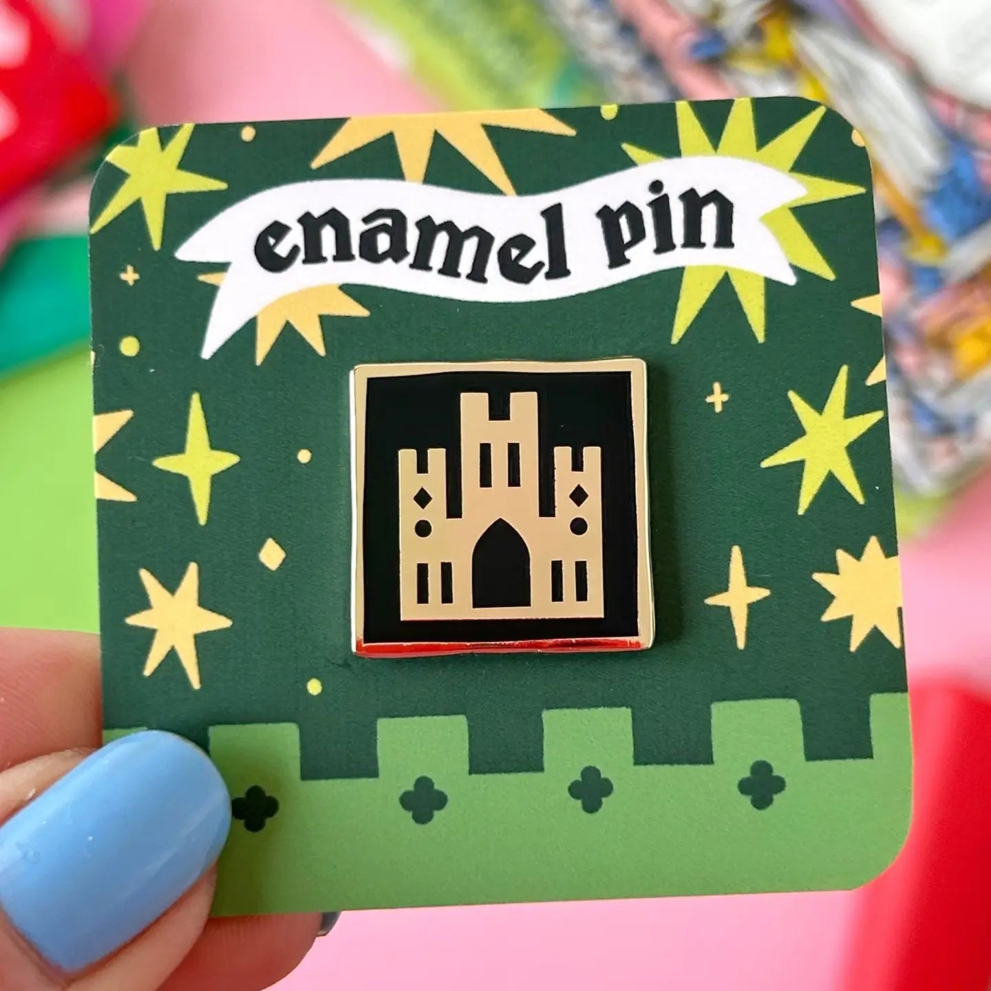 Stacey McEvoy Caunt Medieval Abbey Enamel Pin features a stunning black and gold gothic castle on an ornate display card.