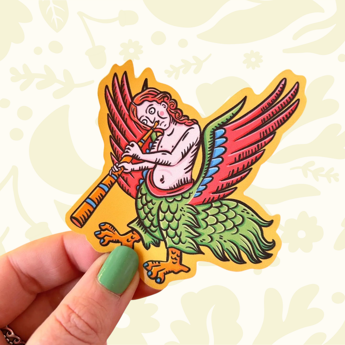 Hand displays a Stacey McEvoy Caunt Medieval Marginalia Harpy Vinyl Sticker, collectible art, August 2026 release.