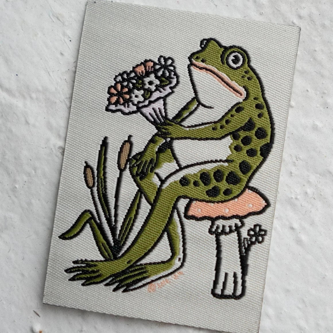 Stay Home Club Froggy Bouquet Patch shows a cute frog on a mushroom with colorful flowers, perfect gift for frog lovers and collectors.