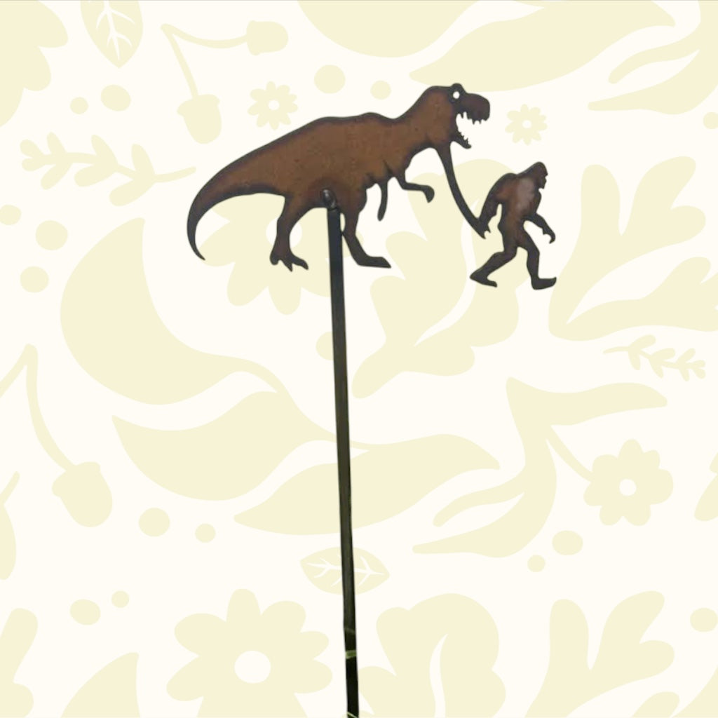 Forager Provisions LTD rustic steel plant stake featuring a silhouette of Bigfoot walking with a T-Rex dinosaur.