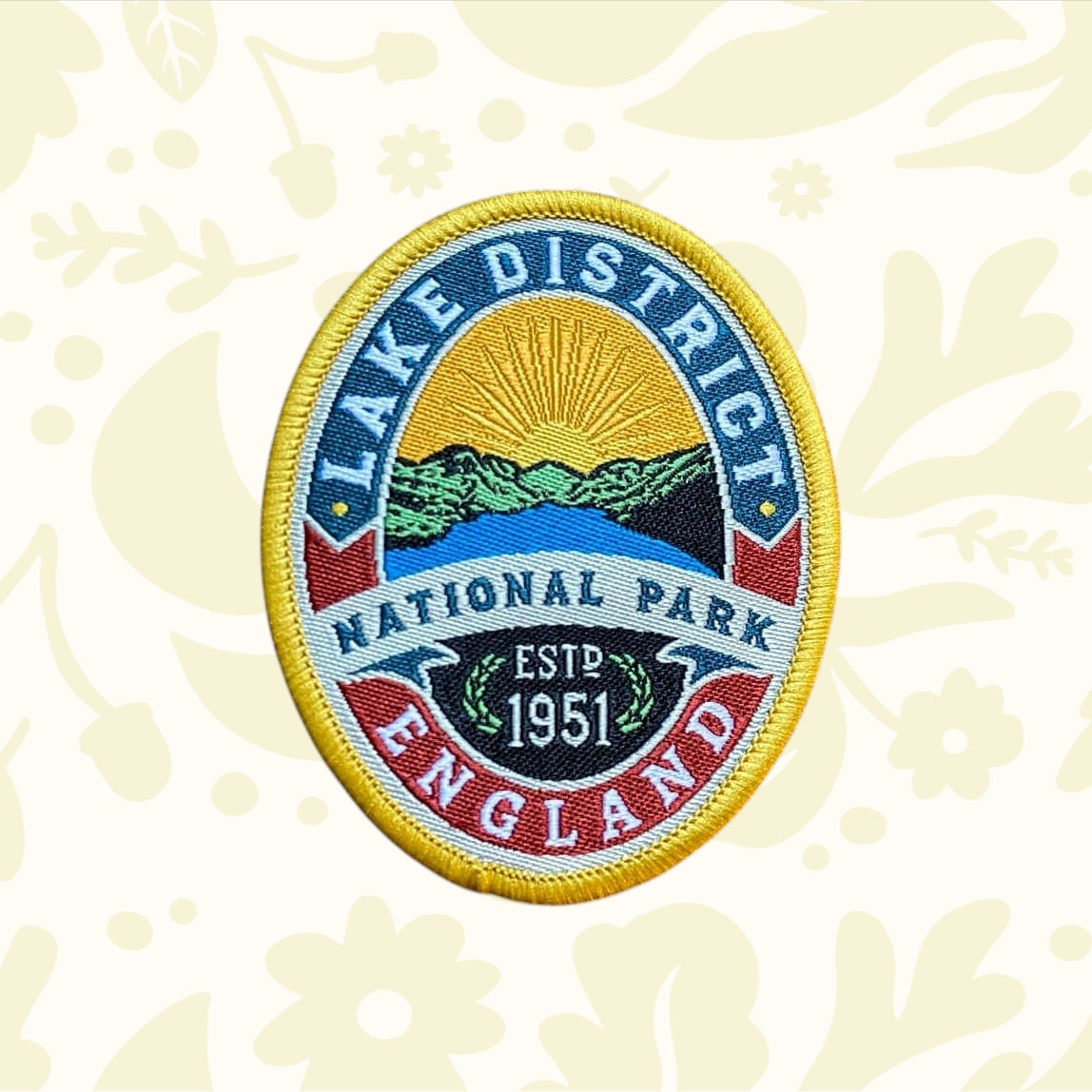 Lake District National Park Patch by Adventure Patch Company on wood, perfect hiking accessory for backpacks or outdoor gear.