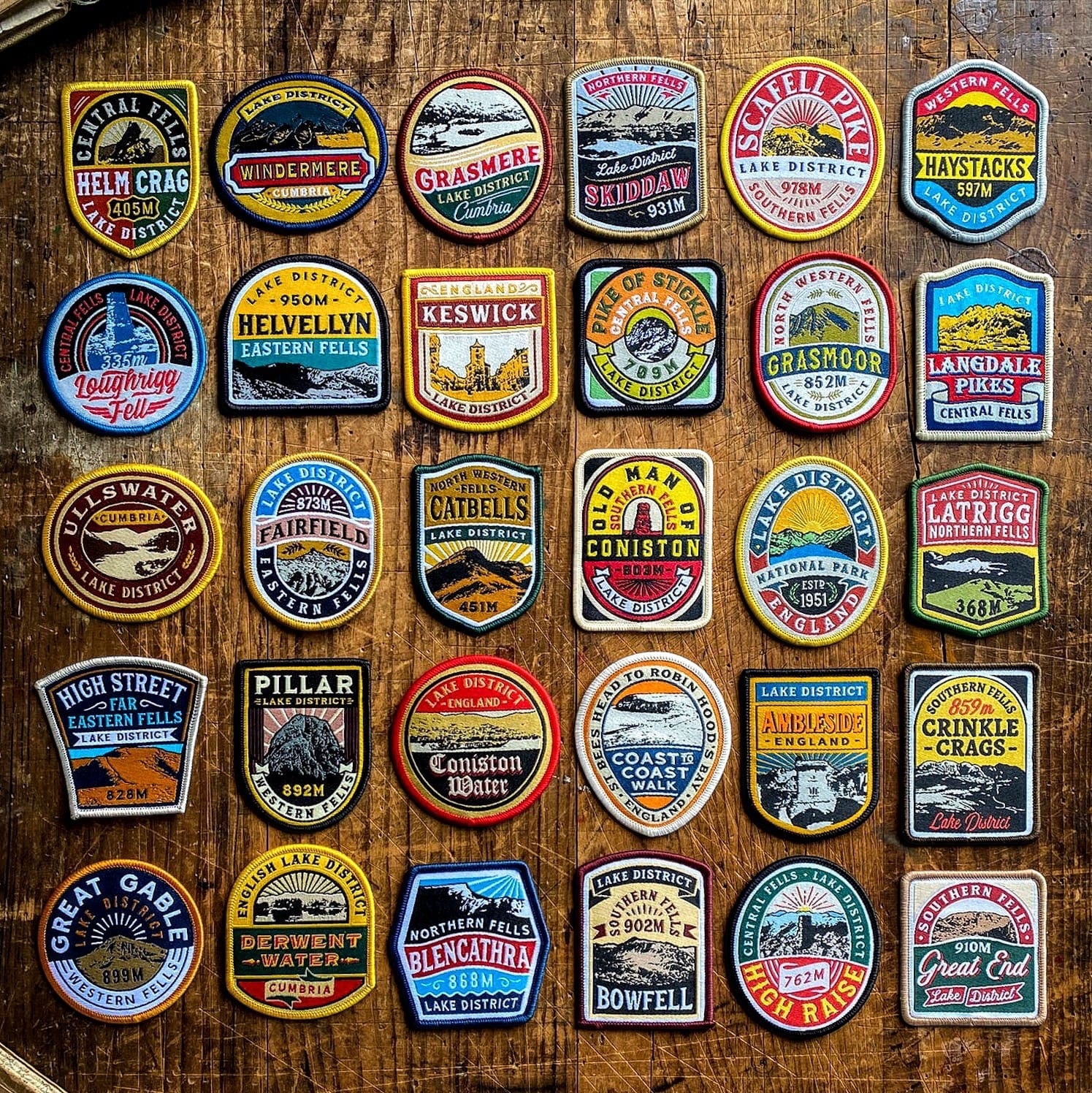 The Adventure Patch Company Lake District National Park embroidered patches—28 vibrant badges arranged in a colorful grid display.
