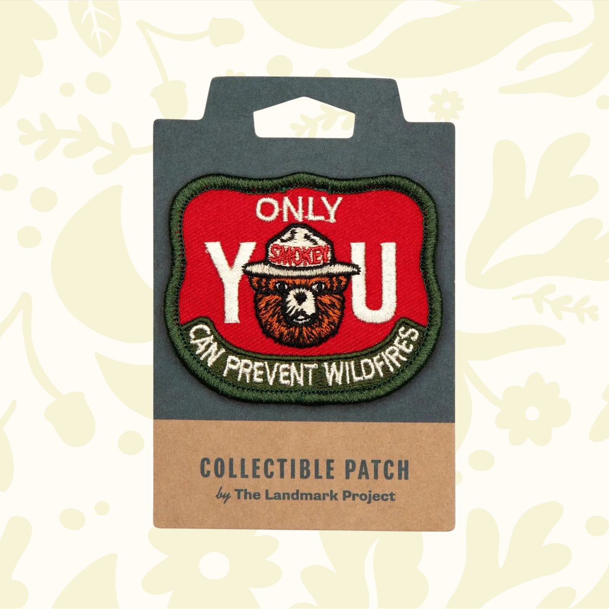 The Landmark Project Smokey Bear Patch - Only You Firewatch features a collectible design showcasing Smokey the Bear's face between large letters spelling "YOU" with the message "ONLY YOU CAN PREVENT WILDFIRES." This officially licensed product from the USDA Forest Service promotes wildfire prevention education.