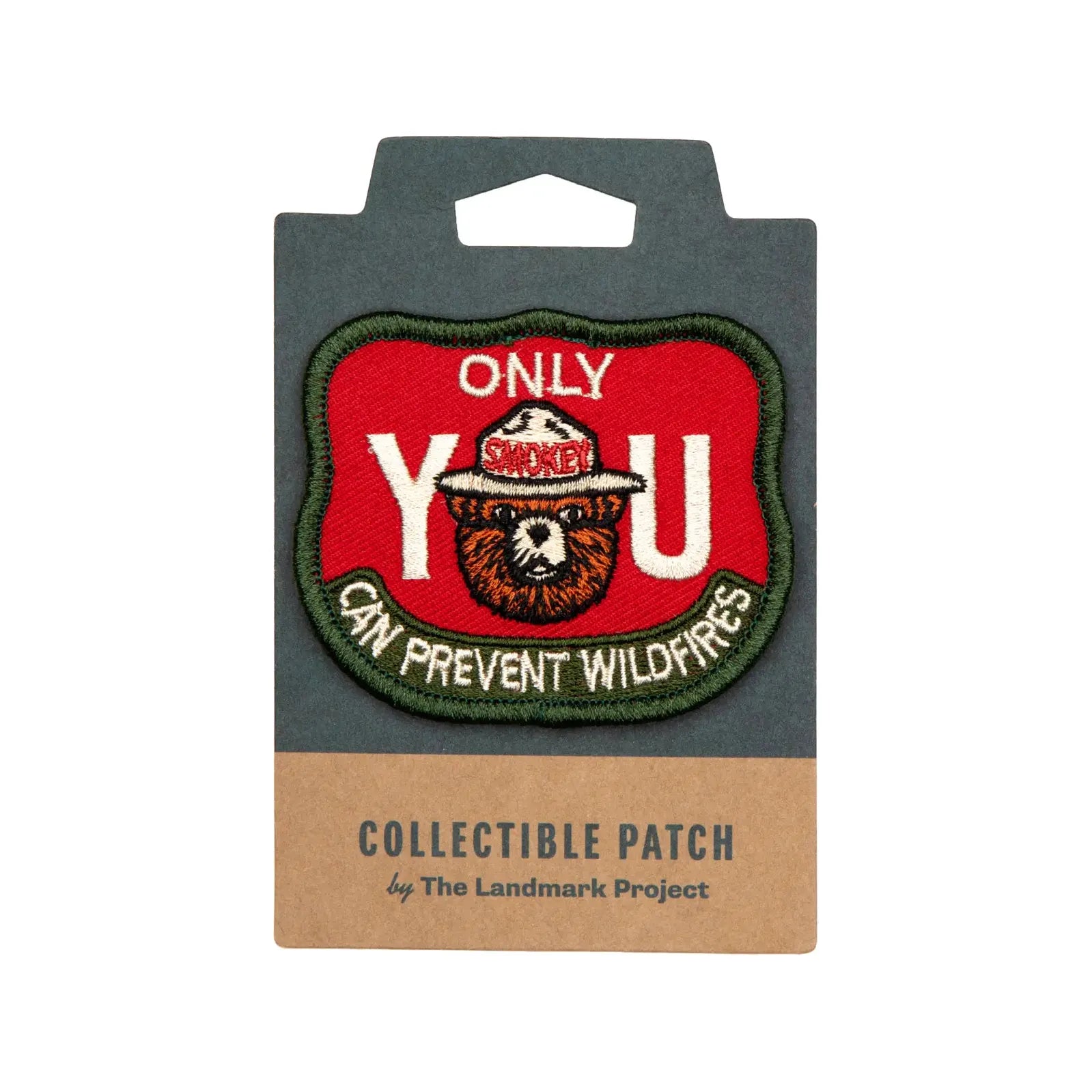 The Landmark Project Smokey Bear Patch - Only You Firewatch features a collectible design showcasing Smokey the Bear's face between large letters spelling "YOU" with the message "ONLY YOU CAN PREVENT WILDFIRES." This officially licensed product from the USDA Forest Service promotes wildfire prevention education.