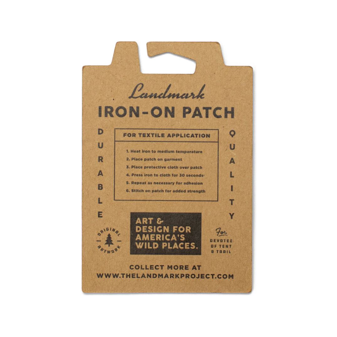 The Landmark Project Mount Rainier National Parks Patch features an illustration of Mount Rainier and trees, labeled "Mount Rainier Natl Park." It's perfect for outdoor adventures and is packaged sustainably.