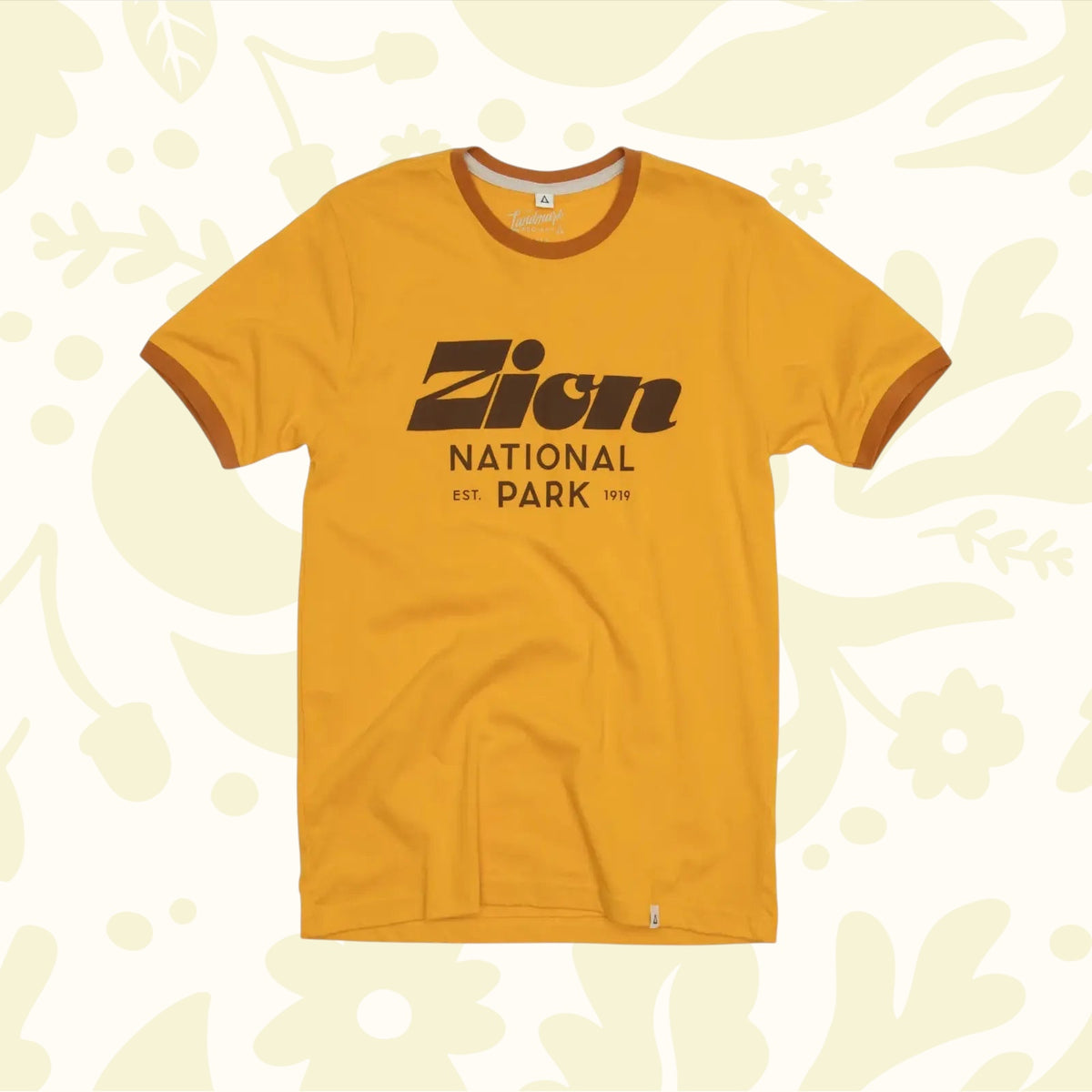 The Landmark Project Zion Script Type T-Shirt in yellow, featuring brown trim and bold brown text that reads "Zion National Park Est. 1919" on the front.