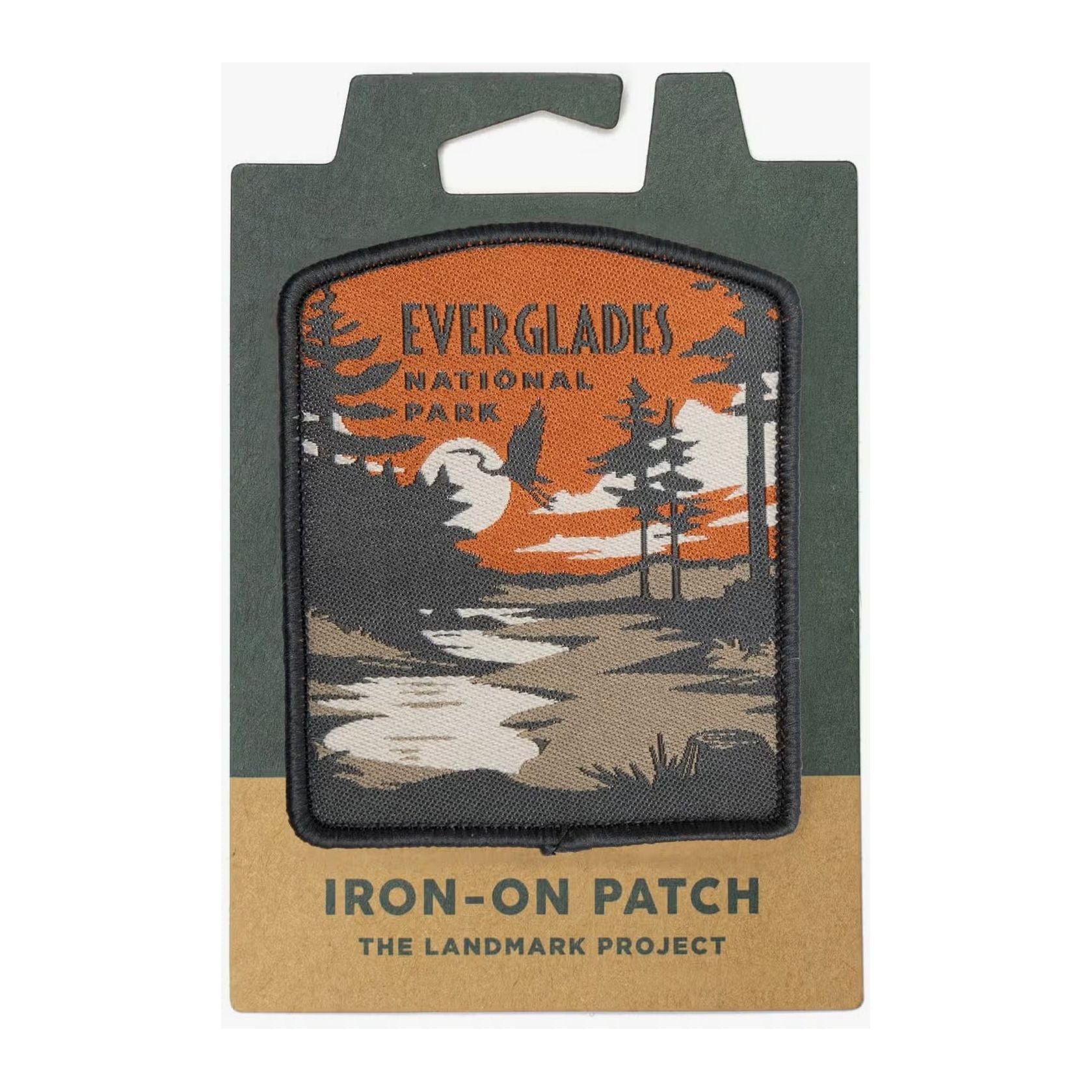 The Landmark Project Everglades National Parks Patch is a rectangular iron-on patch featuring an illustration of Everglades National Park with a vivid orange sunset and serene water scene. It comes packaged on a card using sustainable materials.