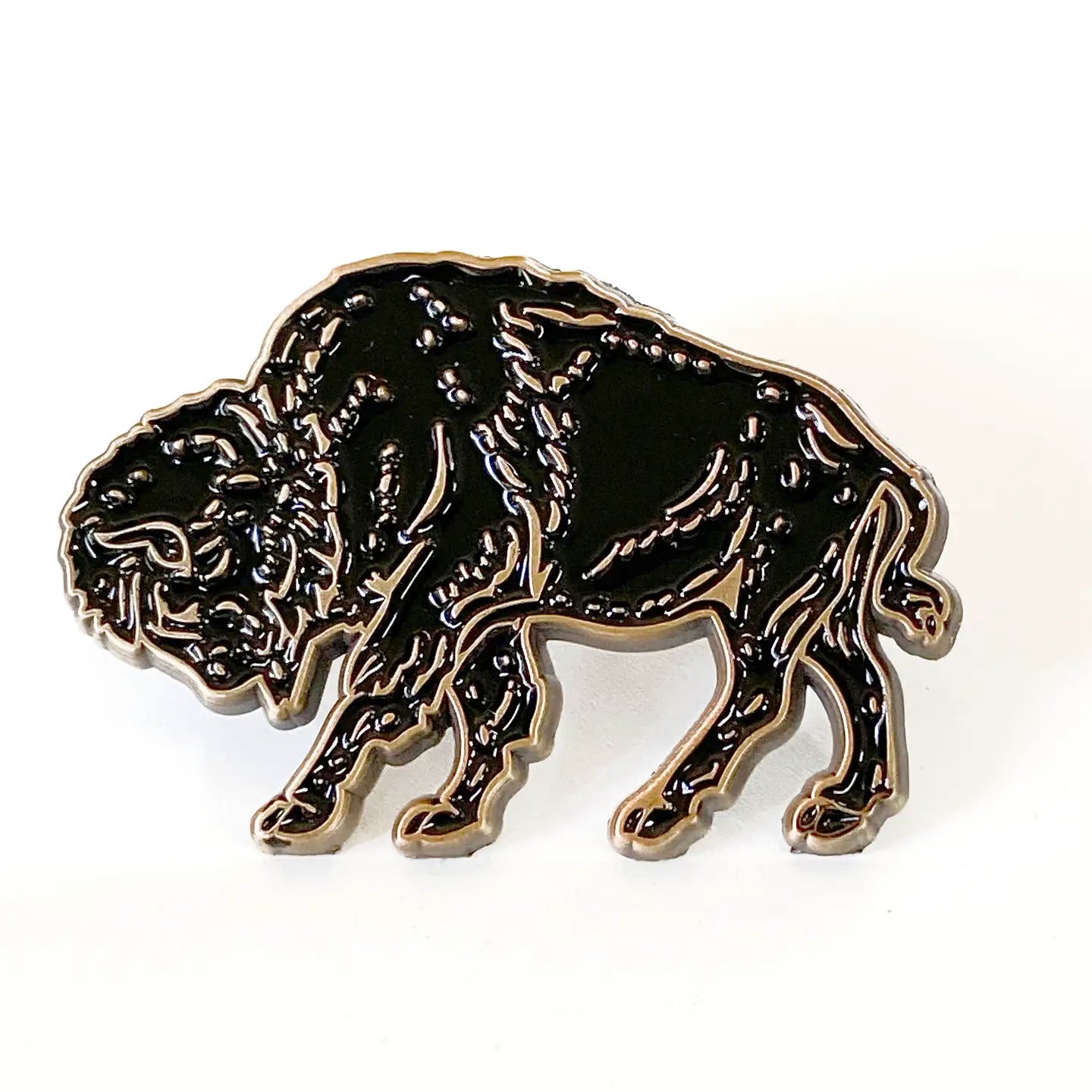Black and gold Wild Wander Bison enamel pin for nature lovers, wildlife accessory displayed on a white background.
